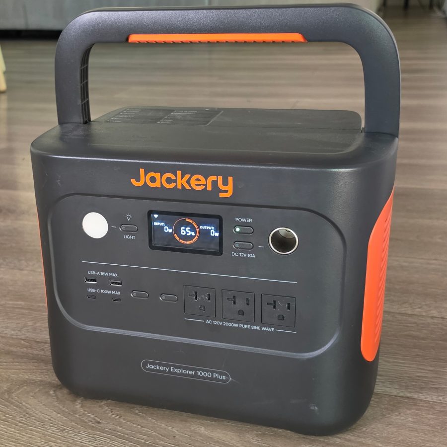 The battery pack: a portable power station with three AC outlets, two USB-C and two USB-A ports, and a carry handle